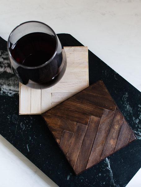 Glass of wine on wood mosaic coaster on a soapstone tray