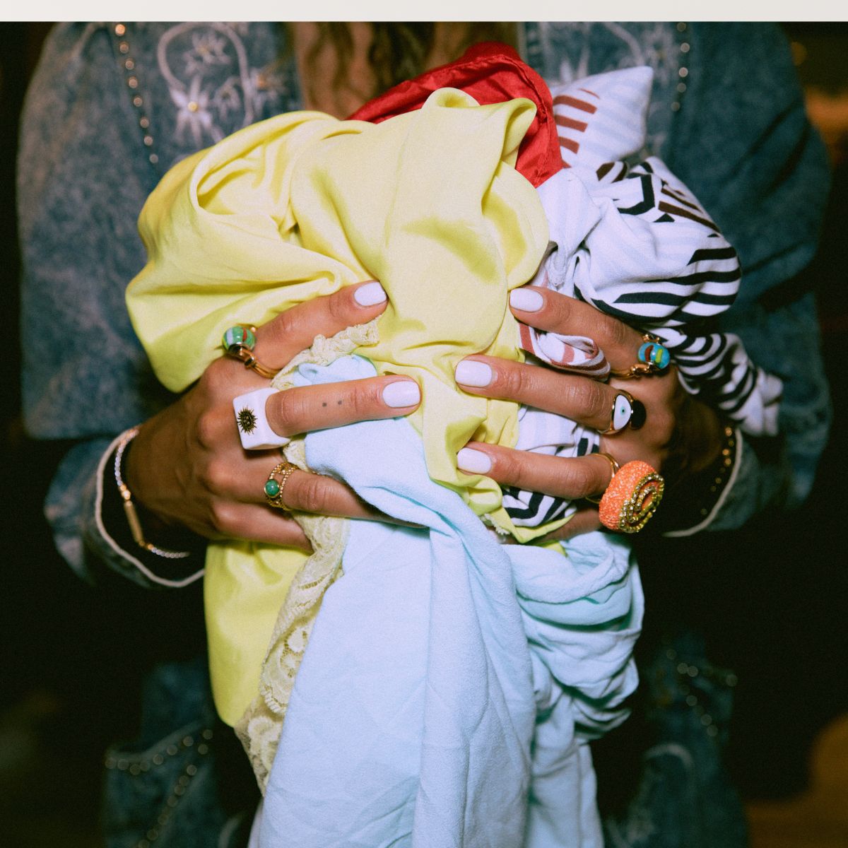 woman with clothes in hand and pretty nails